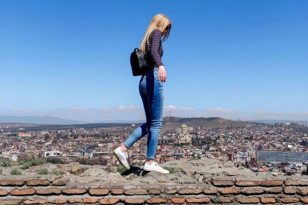 A photo of me walking on a wall at the Narikala Fortress in Tbilisi, Georgia.