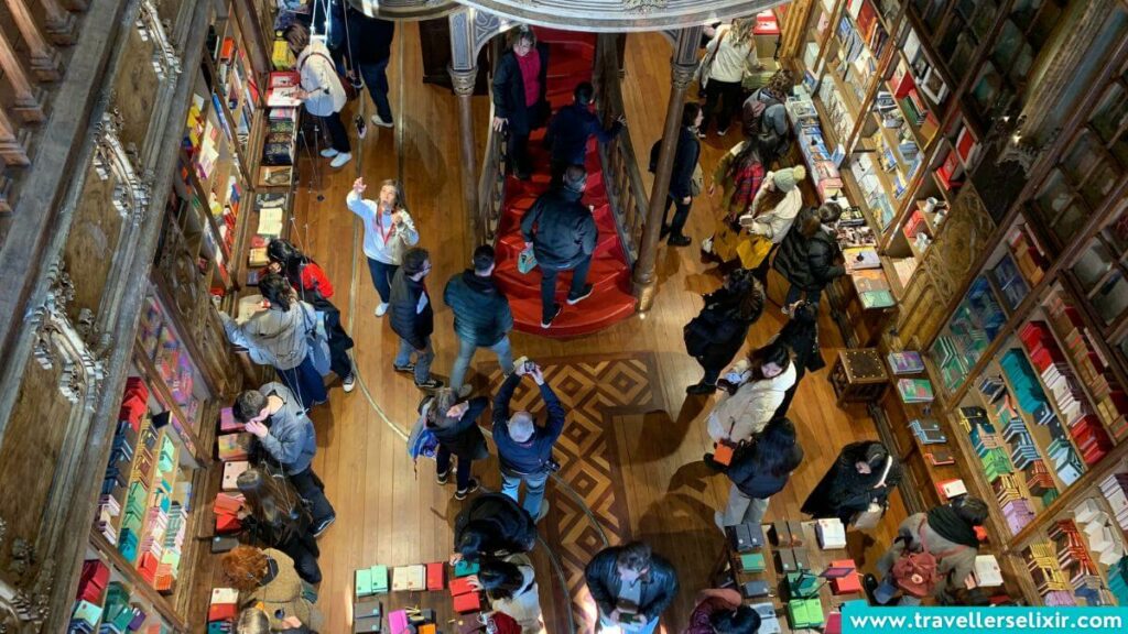 Photo showing how busy it is inside Livraria Lello.