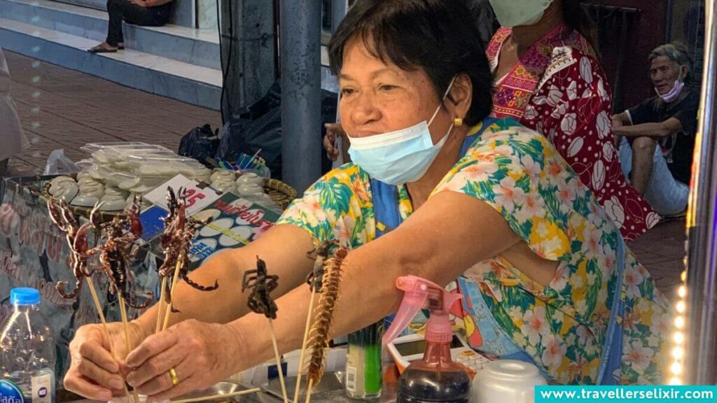 Street vendor in Chinatown, Bangkok selling scorpions.